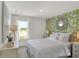 Bright bedroom with natural light, floral accent wall, and elegant decor offers a relaxing retreat at 11614 Hartwell St, Indianapolis, IN 46235