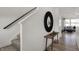 Bright entryway featuring a staircase, console table, and view into the living area at 11614 Hartwell St, Indianapolis, IN 46235