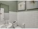 Modern half bathroom with white subway tile and stylish fixtures at 11614 Hartwell St, Indianapolis, IN 46235