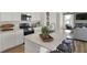 Bright, white kitchen featuring a large island with seating and stainless steel appliances at 11614 Hartwell St, Indianapolis, IN 46235