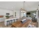 Open-concept kitchen featuring white cabinets, stainless steel appliances, and a spacious island with barstool seating at 11614 Hartwell St, Indianapolis, IN 46235