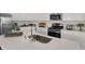 Modern kitchen featuring stainless steel appliances, white countertops, and ample cabinet space at 11614 Hartwell St, Indianapolis, IN 46235