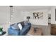Upstairs Living Room boasts modern lighting, comfortable couch, and decorative art at 11614 Hartwell St, Indianapolis, IN 46235