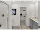 Modern bathroom with walk-in shower, dual sink vanity, and access to a closet at 11620 Hartwell St, Indianapolis, IN 46235