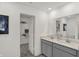 Well-lit bathroom with modern vanity, dual sinks, and a walk-in closet for ample storage at 11620 Hartwell St, Indianapolis, IN 46235