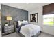 Cozy bedroom with stylish accent wall and a window that provides natural light at 11620 Hartwell St, Indianapolis, IN 46235