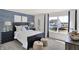 Nautical themed bedroom with striped walls, a cozy bed, and a view of the new home construction at 11620 Hartwell St, Indianapolis, IN 46235