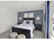 Bedroom features a navy striped accent wall, and natural fiber poufs at 11620 Hartwell St, Indianapolis, IN 46235