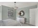Bright bedroom with neutral decor, modern lighting, and a mirror creating a serene space at 11620 Hartwell St, Indianapolis, IN 46235