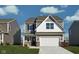 Charming two-story home with gray siding, a two-car garage, and a well-manicured front lawn at 11620 Hartwell St, Indianapolis, IN 46235