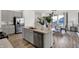 Contemporary kitchen featuring stainless steel appliances, gray cabinetry, and hardwood floors at 11620 Hartwell St, Indianapolis, IN 46235