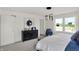 Inviting main bedroom with outside views, modern lighting, and decoratively designed mirror at 11620 Hartwell St, Indianapolis, IN 46235