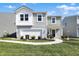 Charming two-story home with a manicured lawn, inviting entrance, and a two-car garage at 11626 Hartwell St, Indianapolis, IN 46235
