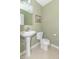 Small bathroom with pedestal sink, toilet, and framed art at 1226 Arlington Dr, Greenfield, IN 46140