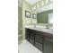 Double vanity bathroom with dark brown cabinets and large mirror at 1226 Arlington Dr, Greenfield, IN 46140