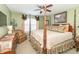 Main bedroom with a four-poster bed, ceiling fan, and large windows at 1226 Arlington Dr, Greenfield, IN 46140