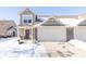 Tan two-story townhouse with snow-covered yard and attached garage at 1226 Arlington Dr, Greenfield, IN 46140