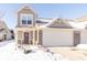Two-story townhouse with attached garage, snow-covered landscaping, and charming front entrance at 1226 Arlington Dr, Greenfield, IN 46140
