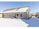 Rear view of townhouse with snow covered yard at 1226 Arlington Dr, Greenfield, IN 46140