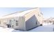 Rear view of townhouse with snow covered yard and icicles at 1226 Arlington Dr, Greenfield, IN 46140