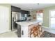 Modern kitchen with stainless steel appliances and an island breakfast bar at 1226 Arlington Dr, Greenfield, IN 46140