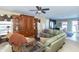Comfortable living room with leather sofas, a wood entertainment center, and a ceiling fan at 1226 Arlington Dr, Greenfield, IN 46140