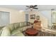 Spacious living room featuring a curved leather sofa and a ceiling fan at 1226 Arlington Dr, Greenfield, IN 46140