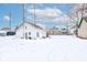 Snowy backyard with detached garage and neighboring houses visible at 1363 & 1367 S Belmont Ave, Indianapolis, IN 46221