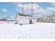 Snowy backyard view, showing a detached garage and neighboring properties at 1363 & 1367 S Belmont Ave, Indianapolis, IN 46221