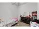 Small bedroom with twin bed, dresser, and shelving at 1363 & 1367 S Belmont Ave, Indianapolis, IN 46221