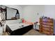 Simple bedroom featuring a double bed and wooden dresser at 1363 & 1367 S Belmont Ave, Indianapolis, IN 46221