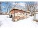 Unfinished brick and stone building exterior in a snowy backyard setting at 1363 & 1367 S Belmont Ave, Indianapolis, IN 46221