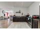Dark wood cabinets, stainless steel appliances, and tile flooring at 1363 & 1367 S Belmont Ave, Indianapolis, IN 46221