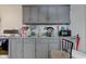 Grey kitchen cabinets, double sink, and range at 1363 & 1367 S Belmont Ave, Indianapolis, IN 46221