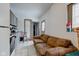 Small kitchen with gray cabinets, a couch, and access to another room at 1363 & 1367 S Belmont Ave, Indianapolis, IN 46221