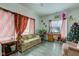 Living room featuring gray floors, floral couch, and a TV at 1363 & 1367 S Belmont Ave, Indianapolis, IN 46221