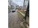 An exterior view of the driveway in need of maintenance and various homes in the background at 1601 Spann Ave, Indianapolis, IN 46203