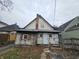 Rear exterior showcasing weathered siding, outdated fixtures, and a chimney at 1601 Spann Ave, Indianapolis, IN 46203