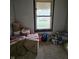 A room in need of renovation filled with insulation, tools, and a view outside the window at 1601 Spann Ave, Indianapolis, IN 46203