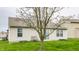 Home exterior featuring a well-maintained lawn and a blooming tree at 1681 Copeland Farms Dr, Greenfield, IN 46140