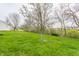 Spacious backyard with well-maintained lawn and mature trees creating a serene outdoor space at 1681 Copeland Farms Dr, Greenfield, IN 46140