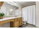 This bathroom features a vanity, sink, toilet, and shower with a shower curtain at 1681 Copeland Farms Dr, Greenfield, IN 46140
