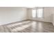 Bedroom with neutral walls, and wood-look floors with natural light from three windows at 1681 Copeland Farms Dr, Greenfield, IN 46140