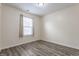 This bedroom boasts wood-look floors and a brightly lit window at 1681 Copeland Farms Dr, Greenfield, IN 46140