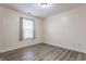 This bedroom boasts wood-look floors and a brightly lit window at 1681 Copeland Farms Dr, Greenfield, IN 46140