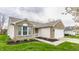 Charming single Gathering home with brick and siding, attached garage and freshly mulched landscaping at 1681 Copeland Farms Dr, Greenfield, IN 46140