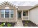 Covered front porch with white railings and brick facade in a single Gathering home at 1681 Copeland Farms Dr, Greenfield, IN 46140