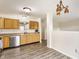 Well-lit kitchen features wood cabinets and wood-look floors at 1681 Copeland Farms Dr, Greenfield, IN 46140
