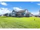 Expansive backyard features a well-manicured lawn and a view of the home's exterior at 19452 Lewis Cir, Westfield, IN 46074