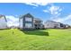 The lush green backyard shows the home's exterior and well-kept lawn at 19452 Lewis Cir, Westfield, IN 46074